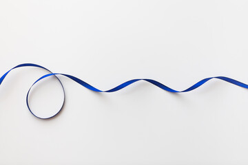 loops of blue ribbon on gray text place.