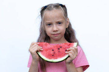 portrait of a little girl eating a watermelon, standing in a pink T-shirt