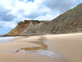 Fototapeta na wymiar Cloudy Burgau beach in the Algarve region of Portugal