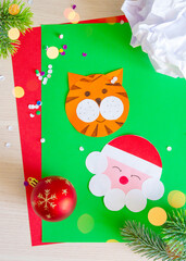 Children's Christmas craft Santa Claus and a tiger. Holiday preparation concept