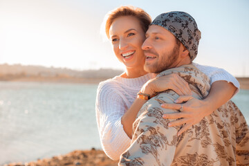 happy couple by the lake at sunset - Image