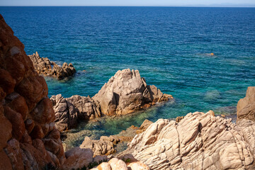 Fototapeta na wymiar Beautiful stone coast splashed by seawater. Look on an open sea.