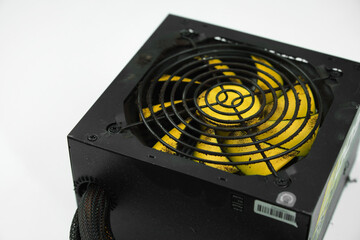 Dusty, dirty power supply. Black case, yellow propeller power supply. Uncleaned, dusty power supply. 