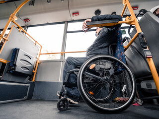 Person with a physical disability inside public transport with an accessible ramp.