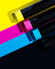 A set of toner cartridges for a color laser printer on the background of SMYK. bright creative concept minimal - obrazy, fototapety, plakaty