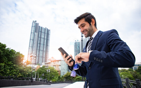Handsome businessman uses his smartphone to connect data and global business with the speed of 6g technology. Abstract world network connection, internet and global connection concept.