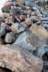 A strip of heaped up various boulders on the coastline