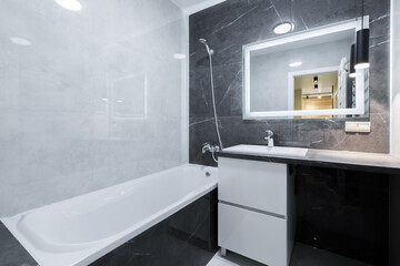 bathroom with black tile interior in a small apartment