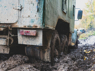 Fototapeta na wymiar USSR military truck URAL on the road. green Russian Cargo Truck stuck in the mud.