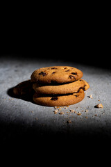 Three stacked chocolate chip cookies