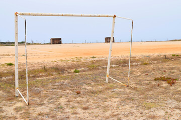 Fototapeta na wymiar Dilapidated soccer goal in weathered sports field in Portugal on the Atlantic coast