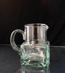Mid-century modern glass jug isolated on black background