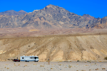 Camper taxing suv on the desert road - 471868542