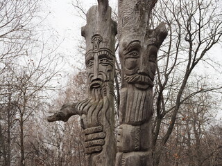 old wooden sculpture in the forest in autumn.