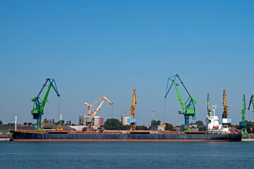 Port cranes unloading ship - 471869741
