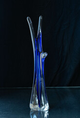 Mid-century modern blue glass vase isolated on black background