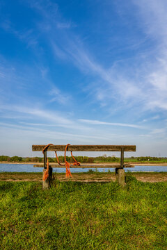 A bench with a view towards the River Rhine on the dyke in Orsoy, North Rhine-Westphalia, Germany