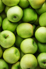 Background of ripe and juicy green apples, perspective from above.