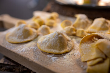 Italian food, fresh home made stuffed pasta tortelli or ravioli dumplings ready to cook, Parma,...