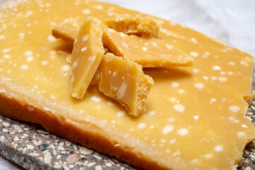 72 months very old Italian parmigiano-reggiano parmesan cheese from Parma has amber color, dry, extremely grainy and crumbly with very intense taste.