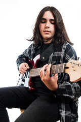 Vertical image on white background of a teenager practicing in his electric guitar class.