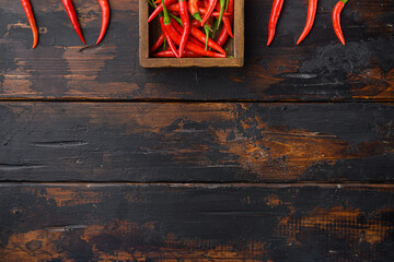 Chili spur pepper , in wooden box, on old dark  wooden table , top view flat lay, with copy space...