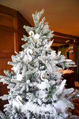 snowy christmas tree with decorations