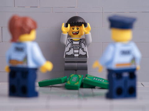 Tambov, Russian Federation - November 26, 2021 Two Lego police officer minifigures arresting a lego thief minifigure. Close up.