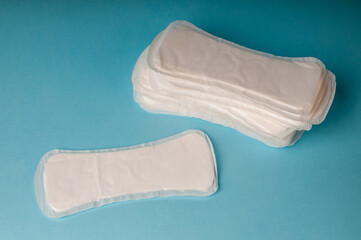 Feminine hygiene pads for the menstrual cycle on a blue background.