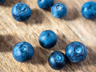 Close-up of ripe delicious blueberries on a wooden background. Healthy natural products, vitamins. selective focus