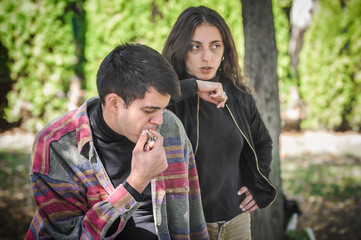 Young couple, woman and man, smoking cannabis marijuana ganja joint