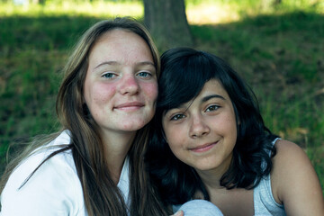 Obraz premium Portrait of two girls in a park in summer.