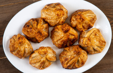 Fried khinkali in a white plate.Georgian cuisine.