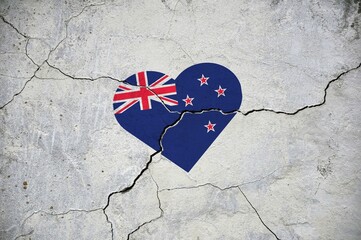 The symbol of the national flag of New Zealand in the form of a heart on a cracked concrete wall.