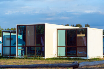 Modular house with large panoramic windows, the concept of prefabricated houses for refugees and...