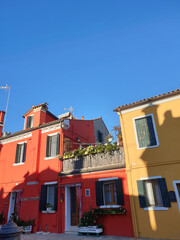 Colorful painted houses facade on Burano island, province of Venice, Italy