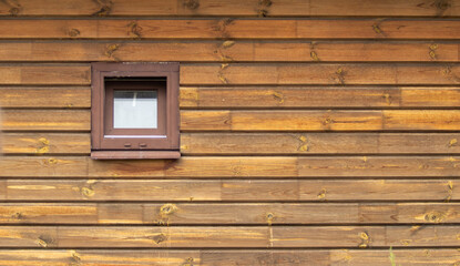 Window in a wooden wall, background of the house.