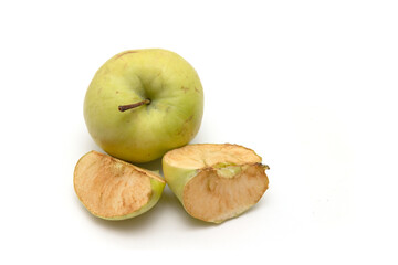 Slices of an old apple on a white background.