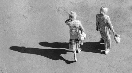 Fototapeta na wymiar People walking on the asphalt, shadow top view.