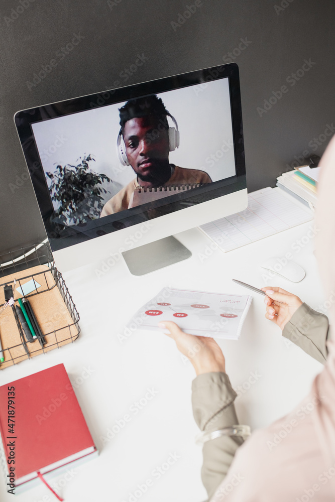 Poster african guy with headphones on computer screen looking at teacher explaining data on paper during on