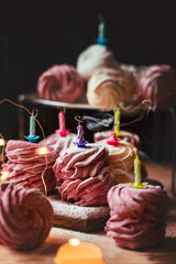 Russian homemade berry zephyr on dark background with birthday candles. Russian sweetness cusine