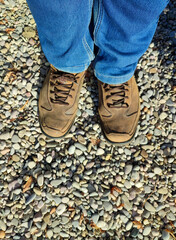 Shoes on the ground in jeans, nature.