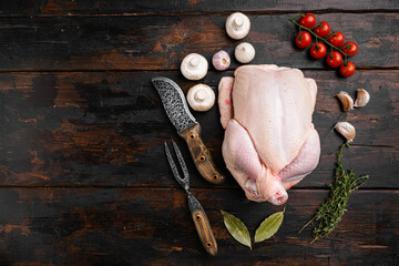 Fresh raw whole chicken, on old dark  wooden table background, top view flat lay, with copy space for text