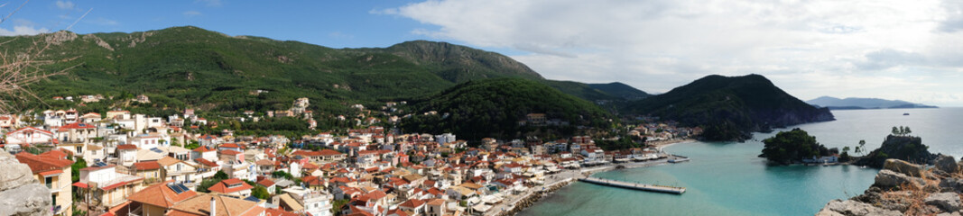 Naklejka na ściany i meble Beautiful panoramic top view at town of Parga,roofs, Ionian sea,Greece from castle. Mediterranean bay,Greek Epirus
