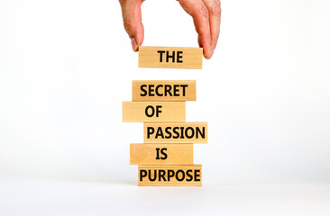 Passion and purpose symbol. Wooden blocks with concept words The secret of passion is purpose. Beautiful white background, copy space. Businessman hand. Business, passion and purpose concept.