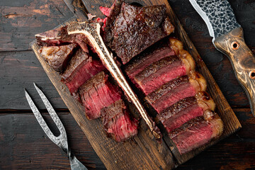 Fresh juicy medium rare Sliced and roast T bone or porterhouse beef meat Steak, on wooden serving...