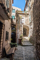Fototapeta na wymiar Characteristic small streets in the historic center of Dolceacqua with arches and flowers