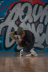Fototapeta na wymiar Modern rapper dancing in garage. Urban lifestyle, hip hop.