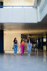 Three girls walking together and going shopping