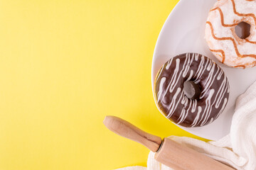 donuts in chocolate glaze on a yellow background, place for text